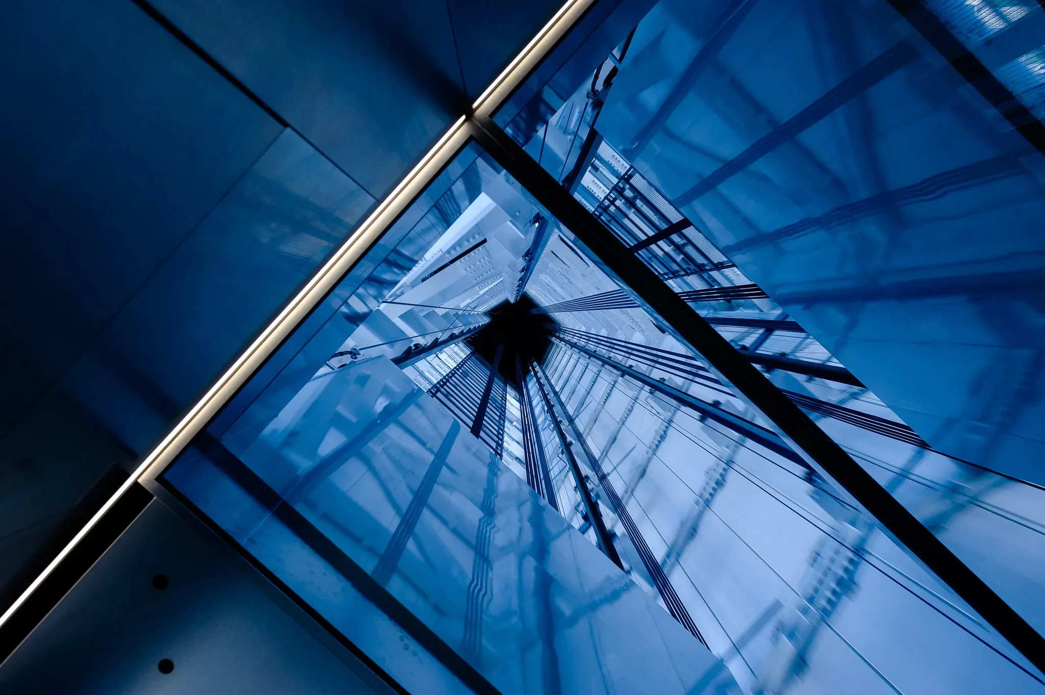 Elevator,Shaft,Design. A blue building with a clock on top of it.